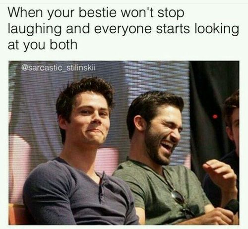 two men sitting next to each other in front of a white sign that says when your bestie wont stop laughing and everyone starts looking at you both